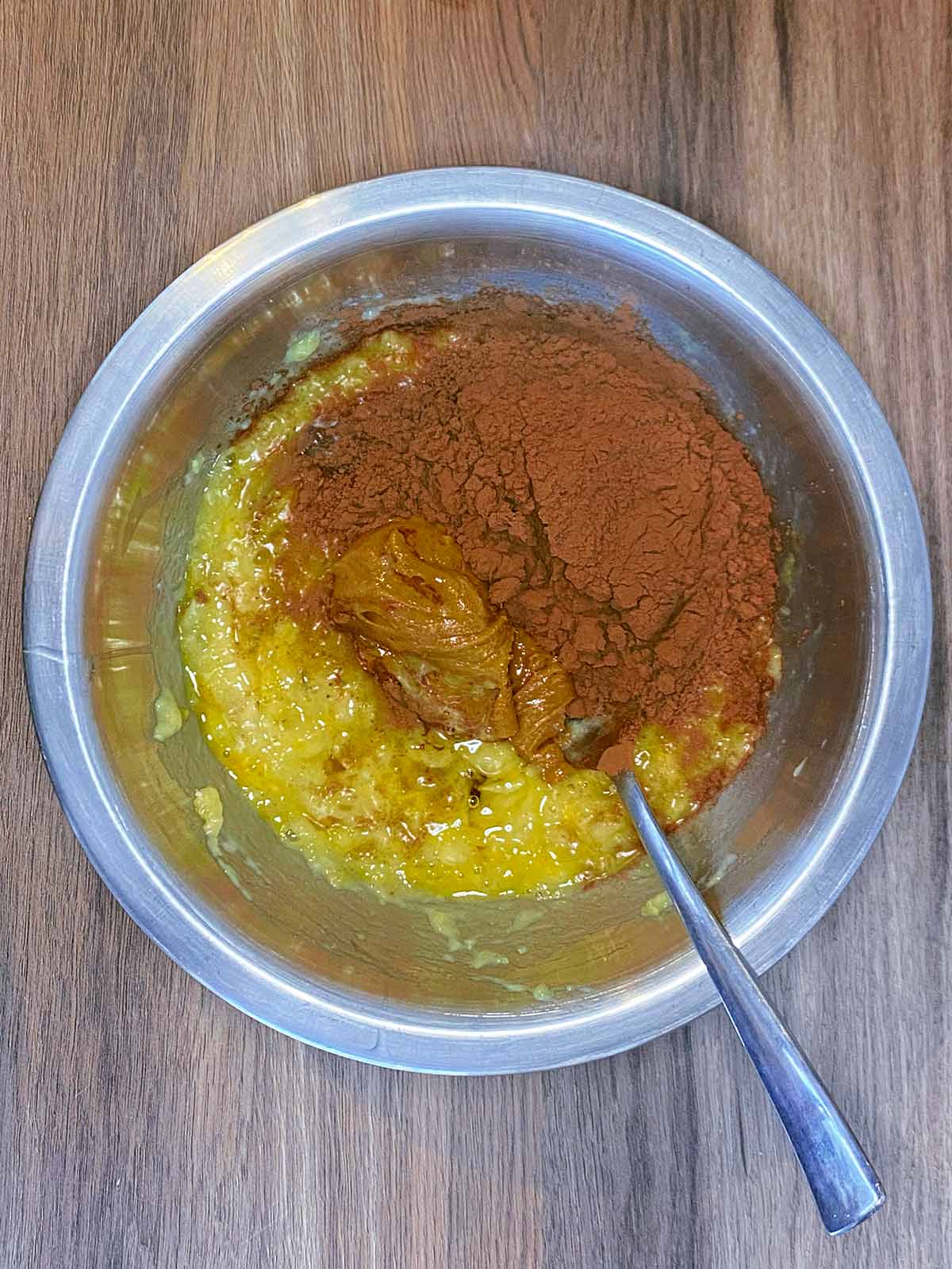 Nut butter, cocoa powder and maple syrup added to the bowl.