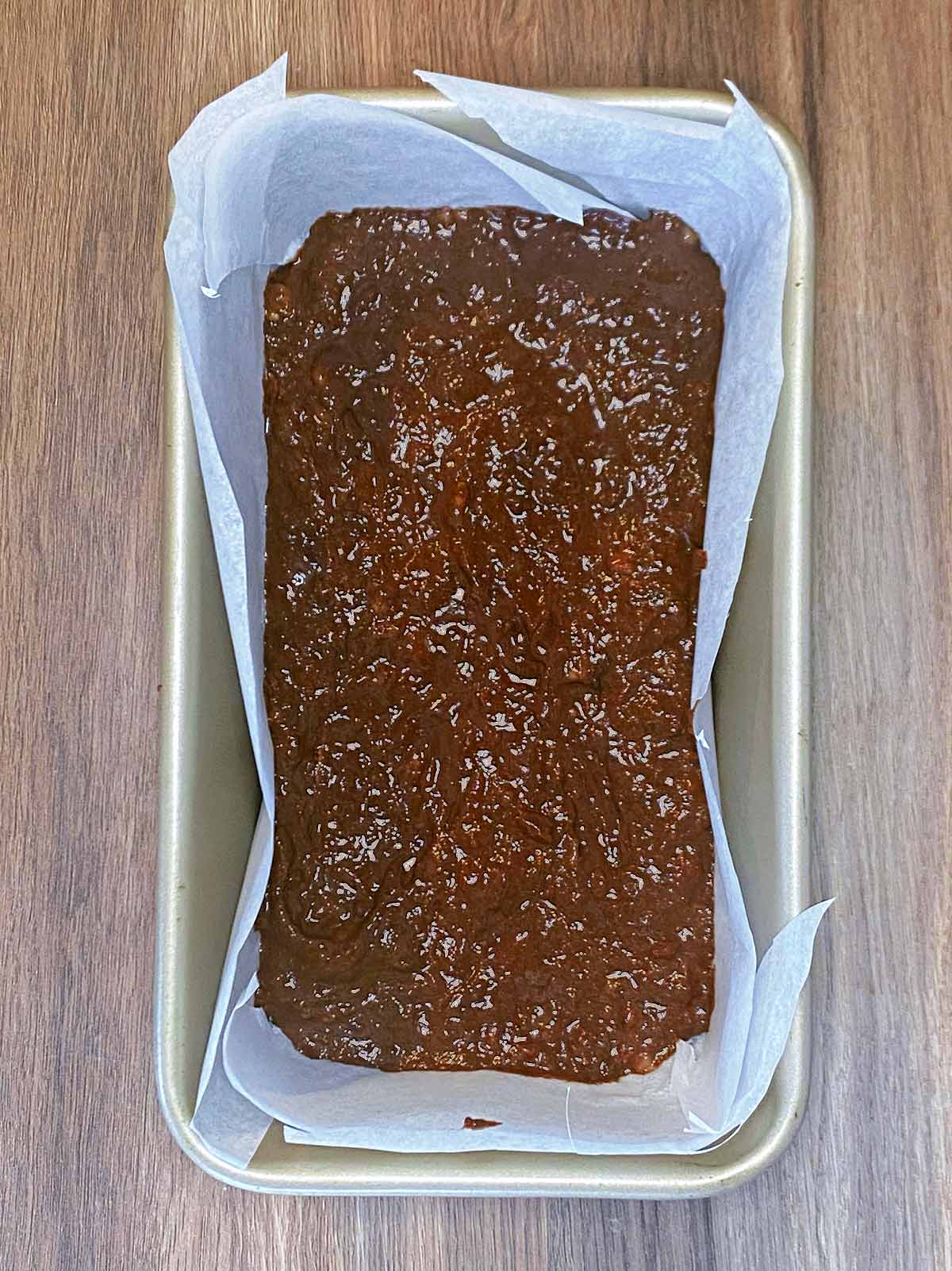 The batter poured into a lined tin.